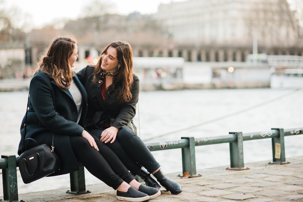 sisters by the seine river in paris france