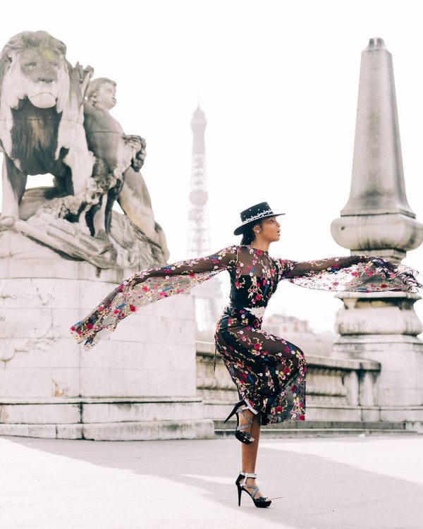 Print for Sale on Paige Gribb Photography - Asja in Motion - A woman in a black embroidered floral dress in front of the Eiffel Tower in Paris, France taken during Paris Fashion Week